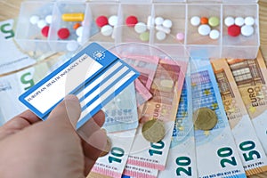 healthcare cardholder holds European health insurance card, euros money, medicines, blue EU document healthcare support, medicines