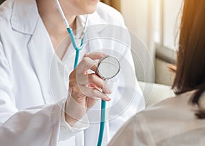 Healthcare concept with cardiologist doctor examining woman patient`s heart health diagnosing cardiovascular disease illness