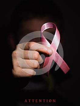 Healthcare concept - child hands holding cancer awareness ribbon