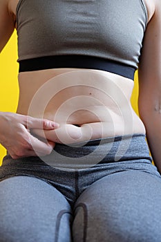 Healthcare concept, Fat overweight women pinching her fat tummy