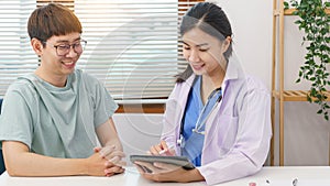 Healthcare concept, Female doctor give advice and writing prescription to patient in clinic