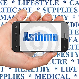 Healthcare concept: Hand Holding Smartphone with Asthma on display