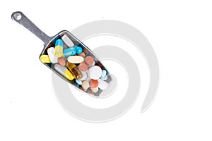 Healthcare concept on overhead view of ladle with scoop of various medicine tablet, caplets, pills, capsule