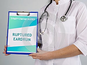 Healthcare concept about RUPTURED EARDRUM with sign on the piece of paper photo