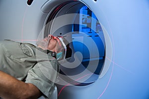 Senior male patient undergoing a MRI examination in a modern hospital