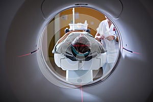 Senior male patient undergoing a MRI examination in a modern hospital photo