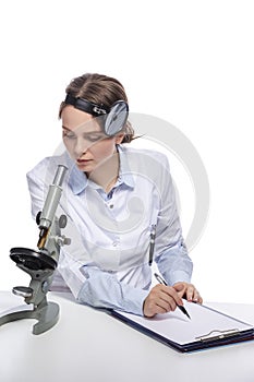 Healthcare Concepts. Professional Caucasian Laboratory Researcher in Smock Working With Microscope While Conducting a Research and