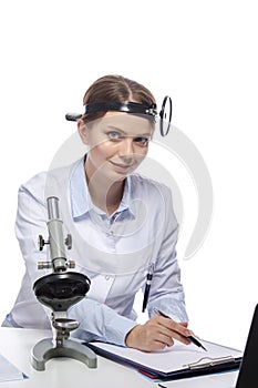 Healthcare Concepts. Professional Laboratory Female Researcher in Smock Working With Microscope While Conducting a Research and