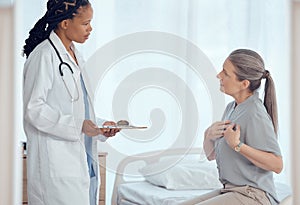 Healthcare, consultation and doctor with senior patient in discussion on chest pain problem. Professional, clipboard and