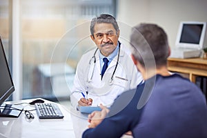 Healthcare, consultation and male doctor talking to a patient about a diagnosis in the clinic. Professional, discussion