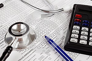 Healthcare costing. Medical phonendoscope, calculator photo