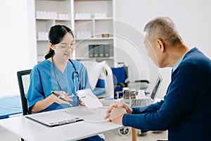 Healthcare costs and fees concept.Hand of smart doctor used a calculator and smartphone, tablet for medical costs at hospital