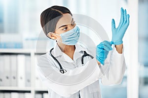 Healthcare, covid and a doctor putting gloves on hands, woman ready for check up examination or surgery in hospital or