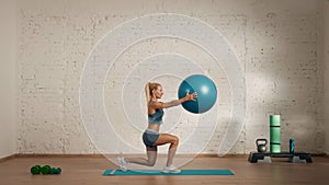 Healthcare creative advertisement concept. Woman fitness coach in the room doing lunges with balance ball.