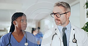 Healthcare, discussion and doctor walking with a nurse in the hospital lobby together before consultation. Collaboration