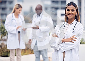 Healthcare, happy and portrait of a doctor with arms crossed for medicine in the city. Smile, pride and a female Indian