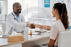 Healthcare, insurance and handshake between a doctor and patient consulting in an office, discussing a treatment plan