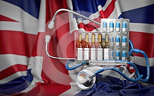 Healthcare, insurance and pharmacy in UK United Kingdom concept. Pills, vaccine, syrringe and stethoscope on UK flag