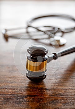 Healthcare Law. Medical stethoscope and judge gavel on lawyer office desk