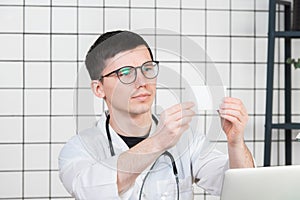 Healthcare and medical concept - doctor with pill box in hospital