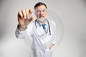 Healthcare and medical concept - doctor with pill in hospital