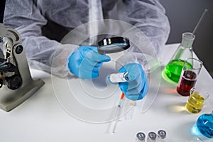 Healthcare and medical concept. Pharmaceutical research and clinical trials concept. Laborer in protective clothing dispenser and