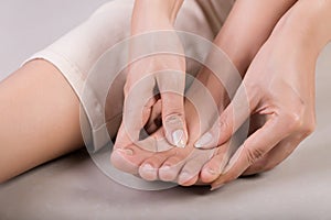 Healthcare and medical concept. Woman massaging her painful foot