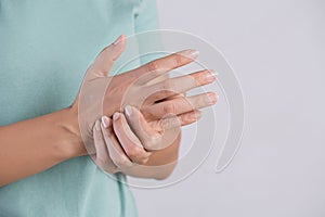 Healthcare and medical concept. Woman massaging her painful hand