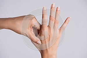 Healthcare and medical concept. Woman massaging her painful hand