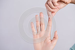 Healthcare and medical concept. Woman massaging her painful Index finger