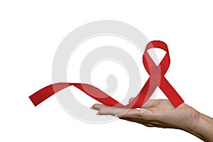 Healthcare and medical, female hand holding red AIDS awareness ribbon. Help red ribbon in support