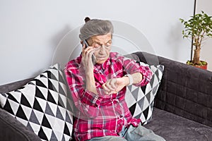 Healthcare, medical, omnichannel and technology concept. Old person using smart watch and while talking to someone on