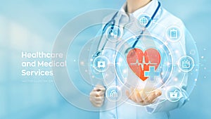 Healthcare, Medical services. Doctor holding in hand red heart shape and medical icon network connection on virtual screen. Health