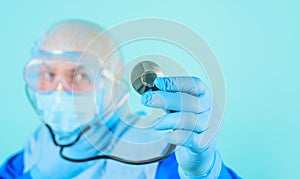 Healthcare and medicine. Closeup of doctor's hand in blue glove with stethoscope. Selective focus. Advertising for