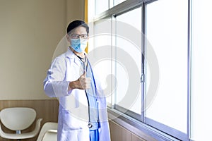 Healthcare and Medicine. Doctor posing with mask and show thump up