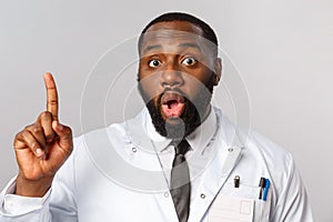 Healthcare, medicine and hospital treatment concept. Close-up of handsome funny african-american doctor talking about