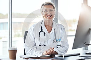 Healthcare, medicine and portrait of a doctor at a desk for medical work, cardiology and surgery. Happy, working and