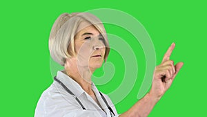 Healthcare, medicine and technology concept - senior female doctor pointing to something or pressing imaginary buttons