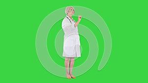 Healthcare, medicine and technology concept - senior female doctor pointing to something or pressing imaginary buttons