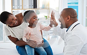 Healthcare, mother and girl gives doctor high five in a doctors office. Medical insurance, healthy child development and