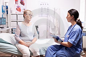 Healthcare nurse telling senior woman diagnosis