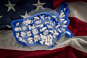 Healthcare, opioid epidemic and drug abuse concept with the map of USA filled with oxycodone and hydrocodone pharmaceutical pills photo