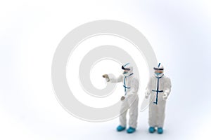 Healthcare and Pandemic Consept. Two doctor miniature figure people wearing Personal Protective Equipment, PPE outfit with