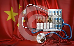 Healthcare and pharmacy in China concept. Pills, vaccine, syrringe and stethoscope in China flag