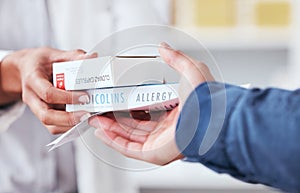Healthcare, pharmacy and medicine in hand of customer with pills, box or allergy medication. Closeup of pharmacist or