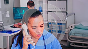 Healthcare physician answering telephone in hospital reception