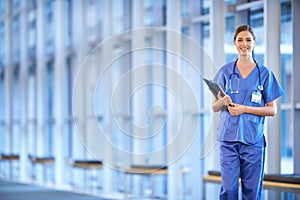 Healthcare, portrait of woman doctor and clipboard standing in a hospital smiling for protection. Nursing, health