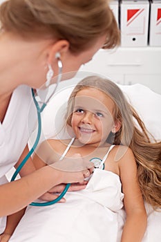 Healthcare professional checking up on little girl