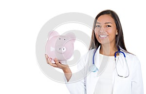 Healthcare professional holding up piggy bank