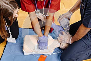Healthcare professionals in scrubs performing medical procedure
